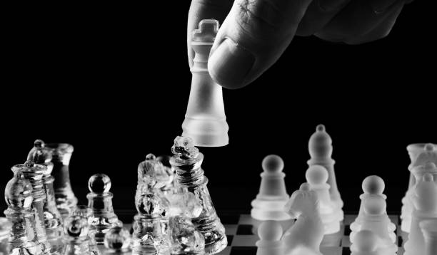 istock Hand of businessman playing chess 891055626