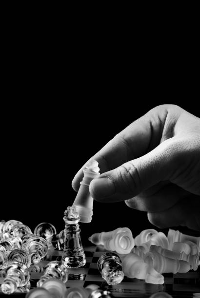 istock Hand of businessman playing chess 891055628
