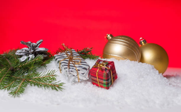 istock Gift wrapping, Christmas tree bump and yellow Christmas tree ball on snow 891057168
