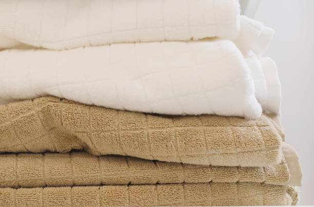 istock Pile of White and Brown Bath Towels 891060264