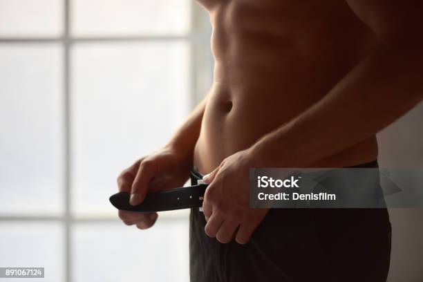 Man Unbuckling Belt Stock Photo - Download Image Now - Men, Sexual Issues, Human Sexual Behavior
