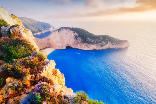 Photo of Greece, Zante island in Ionian Sea, Mediterranean area. Navagio shipwreck bay and beach in summer. Famous iconic natural landmark of Greek island Zakynthos. Sunset aerial view on coastal landscape.