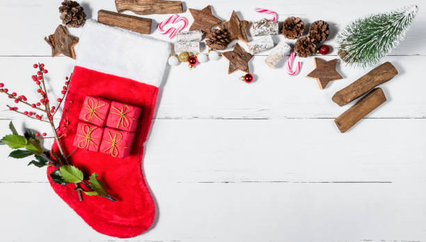 istock Christmas Stocking and Ornaments on White Wooden Table 891069490