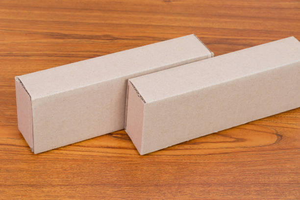 istock Empty Package brown cardboard box for long items on wooden table with copy space. 891103436