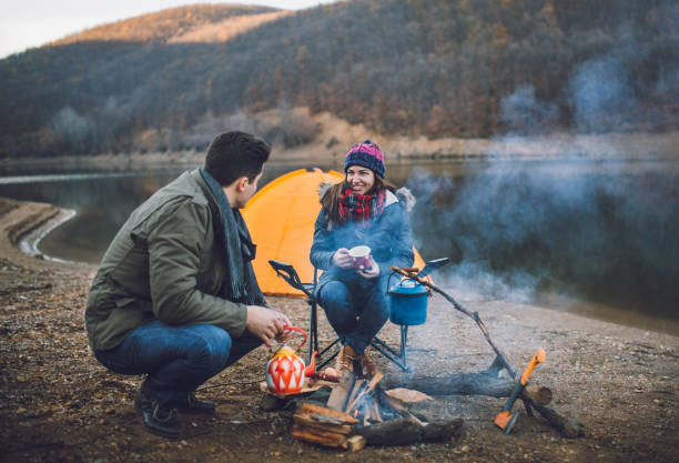 istock Campers next to the campfire preparing food 891107752