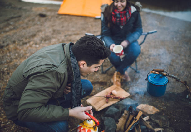 istock Campers next to the campfire preparing food 891107816