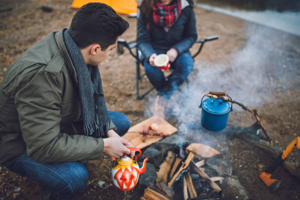 istock Campers next to the campfire preparing food 891107848