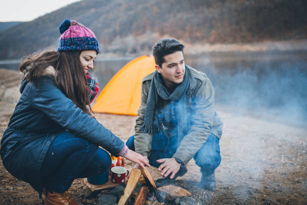 istock Campers next to the campfire preparing food 891108392