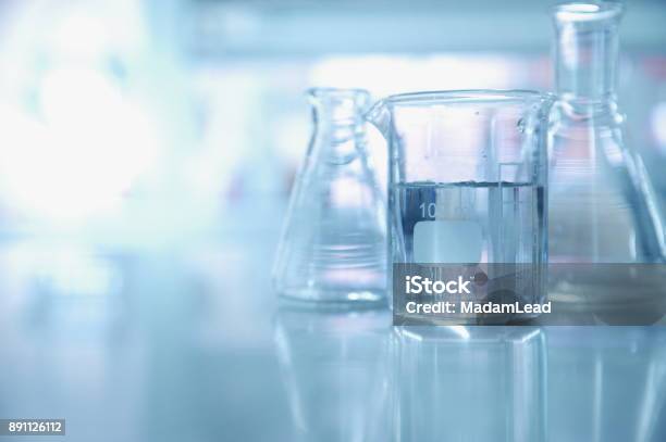 Experiment Water In Beaker And Flask In Chemistry Science Laboratory Background Stock Photo - Download Image Now