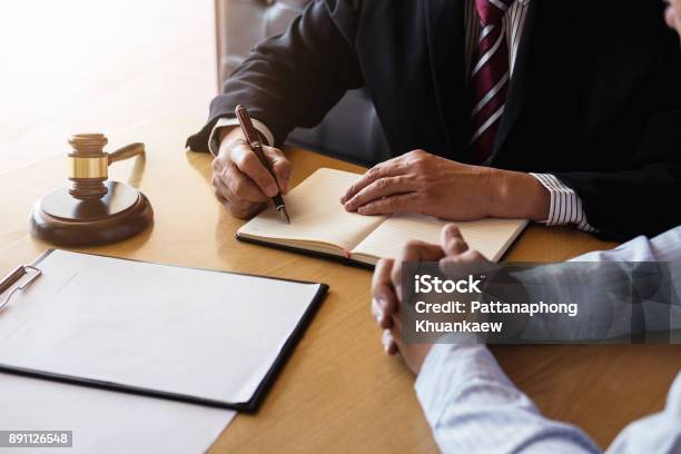 Close Up Of Gavel Male Lawyer Or Judge Consult With Client And Working With Law Books Report The Case On Table In Modern Office Law And Justice Concept Stock Photo - Download Image Now