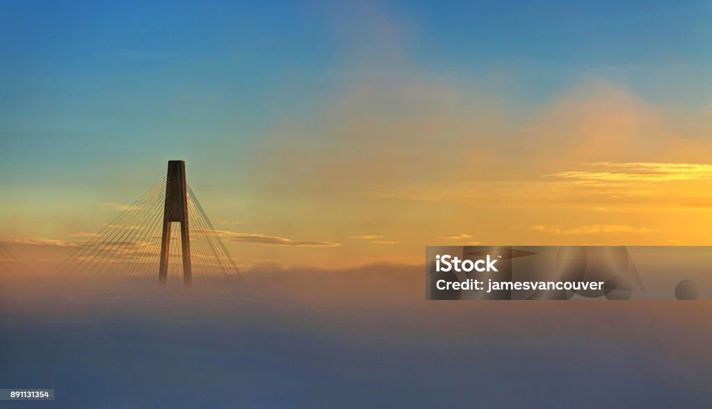 bridge tower with fog at sunrise British Columbia Stock Photo