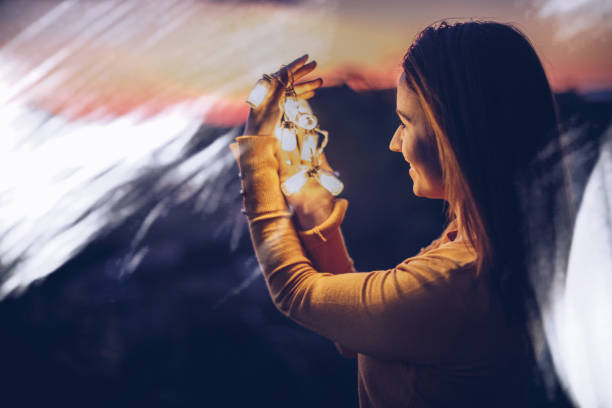 istock Beautiful young woman holding light 891147430