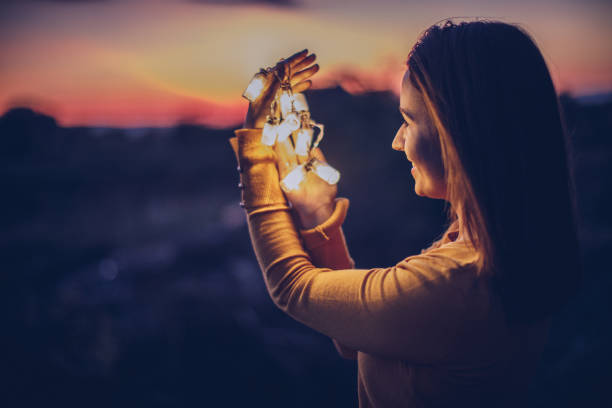 istock Young woman holding light 891148044