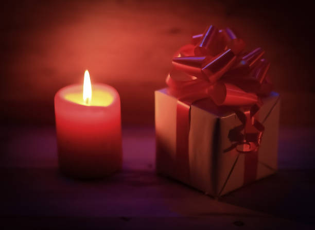 istock two candles and Christmas gift on holiday background 891150420