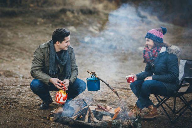 istock Campers next to the campfire preparing food 891150802