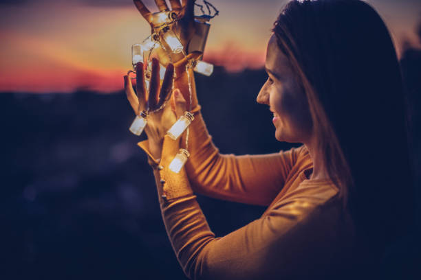 istock Pretty woman holding light 891153068