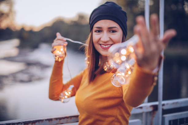 istock Light bulbs and pretty woman 891153264