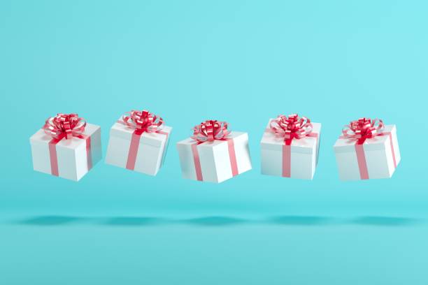 istock White gift boxs with red ribbon floating on white background. minimal christmas concept idea. 891155966