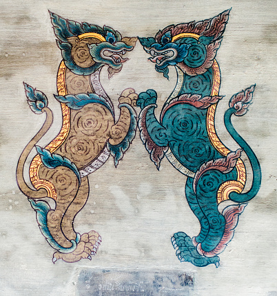 The Singha Lion is a protective deity or symbol in Thai Buddhism. Sometimes mistaken for a dragon or a dog. Thai mural painting on a temple wall at Wat Pho in Bangkok, Thailand, Asia