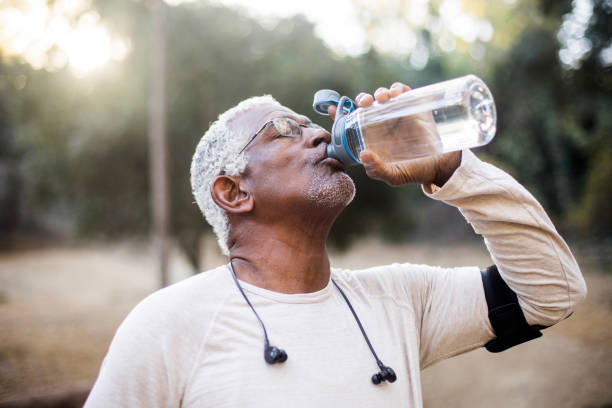 istock Senior African American Man Drinking Water 891167504
