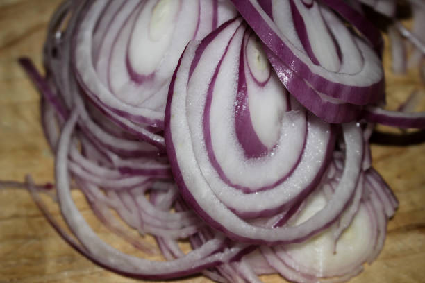 istock Well contrasted sliced onions on a cutting board ready to be ate 891169858