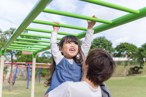 Father and girl playing in the park