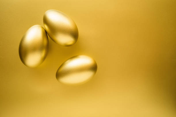 istock Financial success. Golden Egg on golden background 891175238