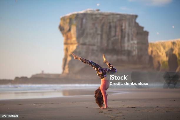 Woman Doing Meditation At Sunset Stock Photo - Download Image Now - Exercising, Healthy Lifestyle, New Zealand