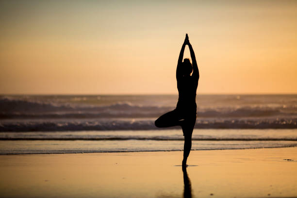 istock Woman doing meditation at sunset 891180924