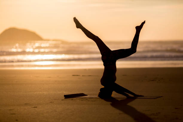 istock Woman doing meditation at sunset 891181240