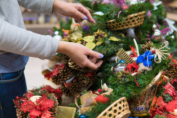 istock customer woman choosing Christmas decorations 891184742