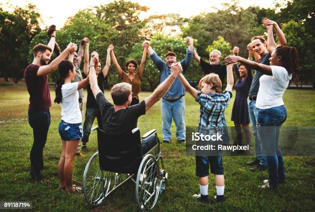 Group Of People Holding Hand Together In The Park Stock Photo - Download Image Now - Community, Multiracial Group, People