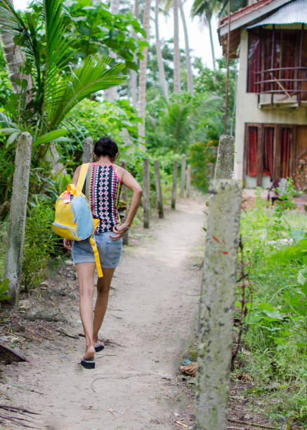 istock Lady Traveler walking down the narrow path 891189888