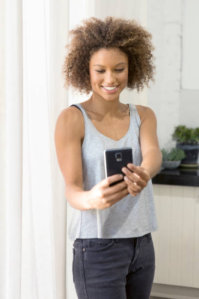 istock Attractive diverse woman using mobile device selfie snapchat video call 891198392