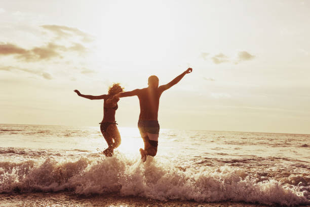 istock Happy couple sunset beach run 891200642