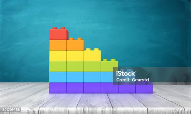 3d Rendering Of A Toy Building Blocks Arranged Into Rainbow Colored Stars On Top Of A Wooden Desk Stock Photo - Download Image Now