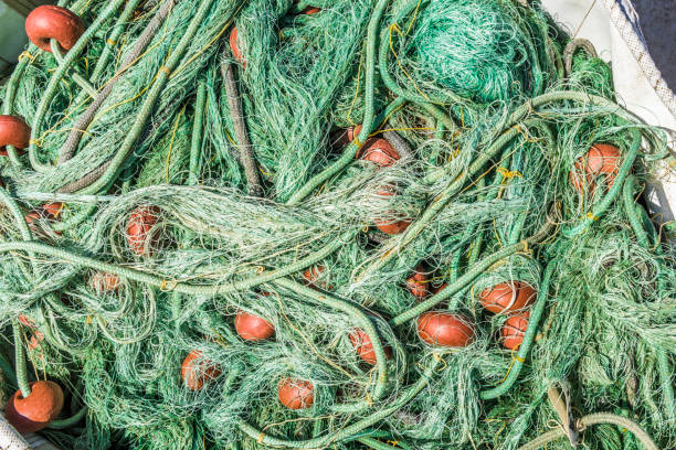 Fishing nets neatly stacked in a big bag on the deck of a small fishing boat in the Marina on the island of Cyprus.