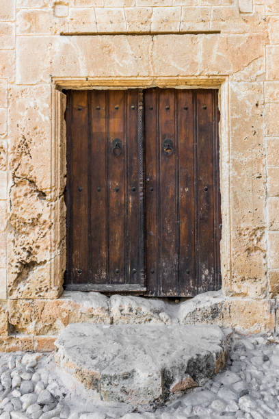 Very old wooden door in a stone Greek house in the centre of the island of Cyprus.