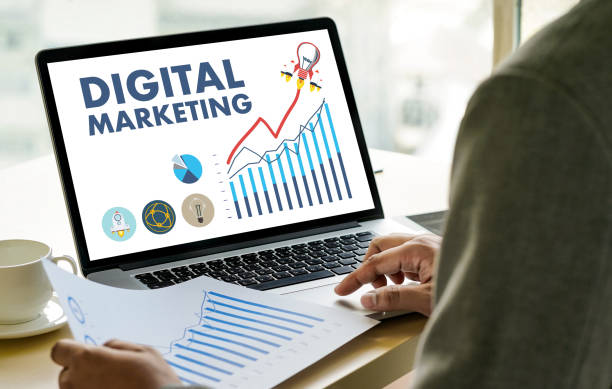 istock DIGITAL MARKETING new startup project MILLENNIALS Business team hands at work with financial reports and a laptop 891245734