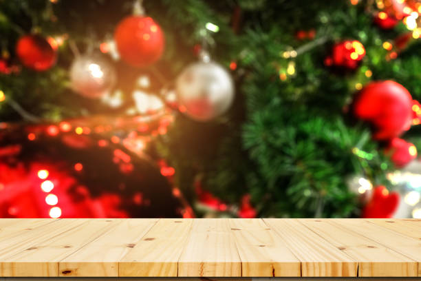istock Wood table top with bokeh from decorative light on Christmas tree in background - can be used for display or montage your products 891245794