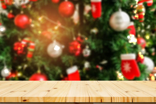istock Wood table top with bokeh from decorative light on Christmas tree in background - can be used for display or montage your products 891245814
