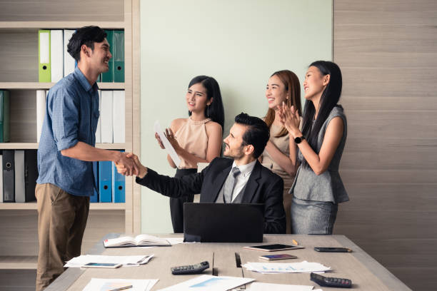 business people clapping in office after signing agreement, Achievement, congratulation and appreciation concept stock photo