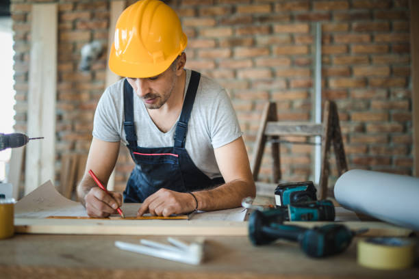 istock Manual worker making measurements on housing project at construction site. 891276672