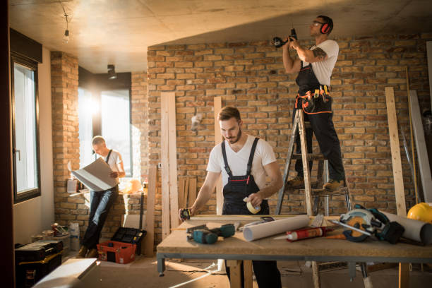 istock Busy construction workers working on home improvement in the apartment. 891281032