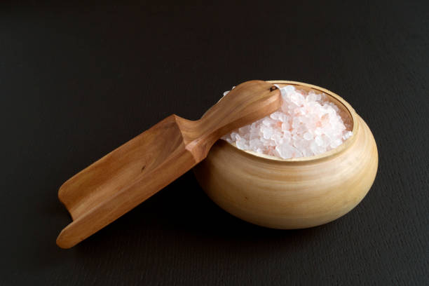 istock Pink salt in wooden bowl. 891289464