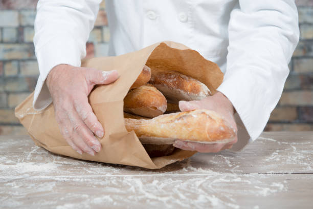 istock a baker holding traditional bread french baguettes 891294690