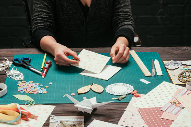 istock cropped image of designer sitting at table and making scrapbooking postcard 891297216