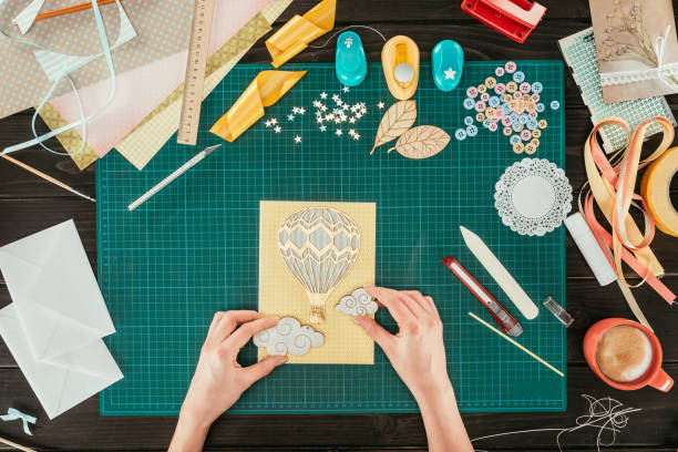 istock cropped image of designer adding clouds to scrapbooking handmade postcard 891297404