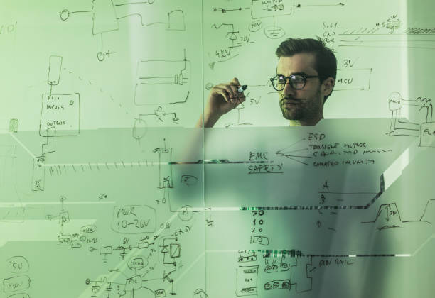 istock Young engineer drawing business ideas on a glass in the office. 891303248