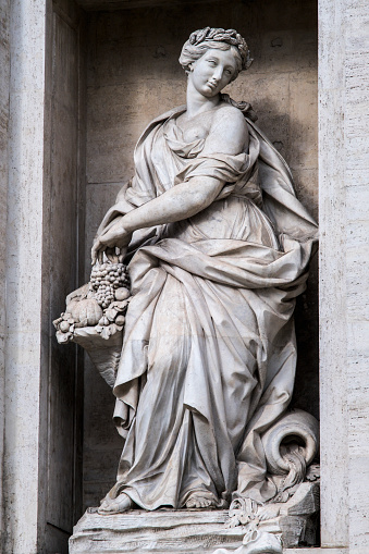 Statue representing the abundance in the Trevi Fountain in Rome, Detail of one of the statues of the fountain completed in 1762 belongs to the late baroque.